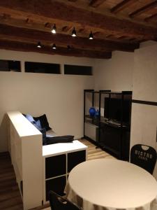 a living room with a white table and a tv at Isi GuestHouse 29 in Iesi