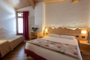 Postel nebo postele na pokoji v ubytování Hotel Cova