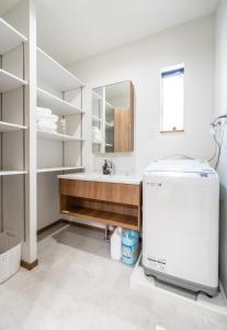 a bathroom with a sink and a mirror at HANASTAY花渓居 · 海（UMI) in Osaka +64 photos