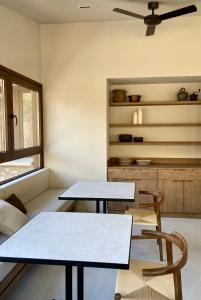 two tables and two chairs in a room at Les Nous Hotel in Rialp