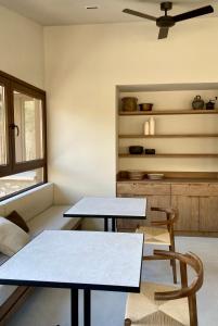 two tables and two chairs in a room at Les Nous Hotel in Rialp +5 photos