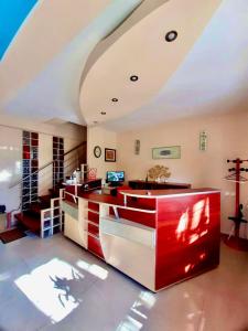 a living room with a red counter and stairs at Vila Miluna in Mamaia