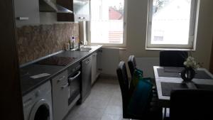 a kitchen with a sink and a dishwasher at Workers Sleep in Wilhelmshaven +2 photos