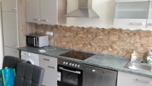 a kitchen with a stove top oven next to a sink at Workers Sleep in Wilhelmshaven