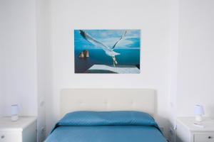 a bedroom with a bird flying over the water at Capri holiday home with a sea view in Capri