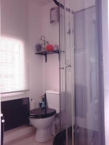a bathroom with a toilet and a glass shower at Les Florides in LʼIsle-sur-la-Sorgue