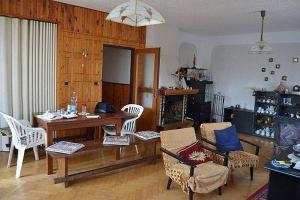 a living room with a wooden table and chairs at Chata Franco in Železnice
