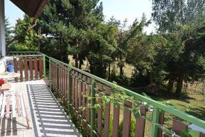 a green fence with a table and chairs on a porch at Chata Franco in Železnice