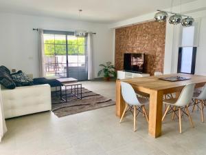 a living room with a wooden table and chairs at Villa Santa Maria in Costa Teguise