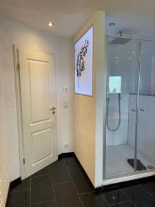 a bathroom with a shower and a glass door at Heidezeit 5 in Neuenkirchen