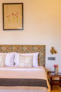 a bedroom with a bed with a headboard at Seclude Shimla, Taraview in Shimla