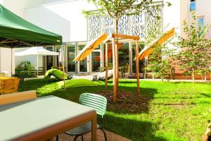 a table and chairs in front of a building at The People - Tours in Tours