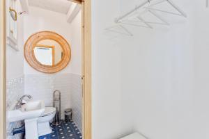 a bathroom with a sink and a mirror at Maison d'Orange - La Pinede in Saint-Tropez