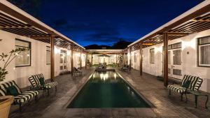 a swimming pool in the middle of a house at Drostdy Hotel in Graaff-Reinet