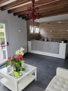 a living room with a table with flowers on it at Boutique Hotel Nuovo Cason in Cavallino-Treporti