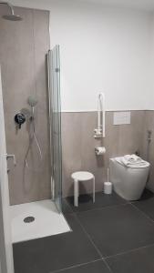 a bathroom with a shower and a toilet and a sink at Boutique Hotel Nuovo Cason in Cavallino-Treporti