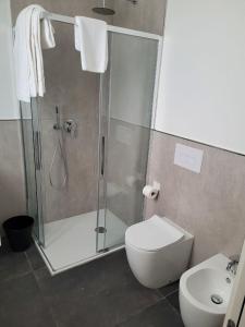 a bathroom with a shower and a toilet and a sink at Boutique Hotel Nuovo Cason in Cavallino-Treporti
