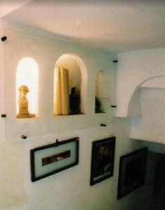 a room with some pictures on the wall at la maison de l'architecte in Hammamet
