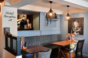 a dining room with a table and two chairs at Mill On The Soar by Greene King Inns in Broughton Astley