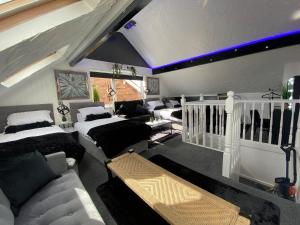 a living room with couches and a couch at NEW…THE HOTTUB HOUSE BLACKPOOL PLEASURE BEACH in Blackpool