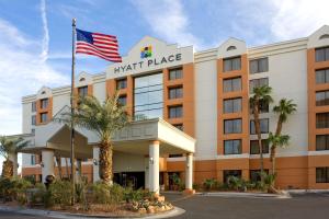 
a large building with a flag on top of it at Hyatt Place Las Vegas in Las Vegas
