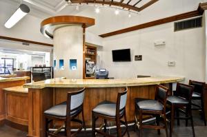 a bar in a restaurant with chairs around it at Hyatt Place Las Vegas in Las Vegas