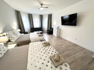 a living room with a couch and a flat screen tv at GrandLux Villa & Spa in Teplice