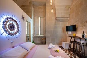 a bedroom with a large bed and a bathroom at MIOE in Muro Leccese