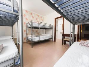 a bedroom with two bunk beds and a desk at Albergue O Cruceiro in Caldas de Reis