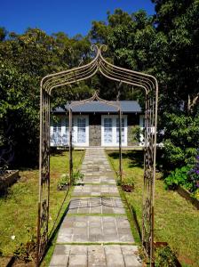 an archway in front of a house at Elegant bluestone cottage located at the Red Hill Peony Estate in Red Hill