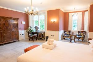 a living room with orange walls and a dining room at Weston Manor Hotel in Bicester