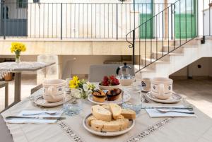 a table with a plate of bread and food on it at MIOE in Muro Leccese