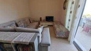 a living room with a couch and a table at Sea View apartment in Vlorë
