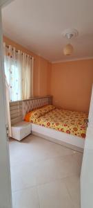 a bedroom with a bed and a window at Sea View apartment in Vlorë
