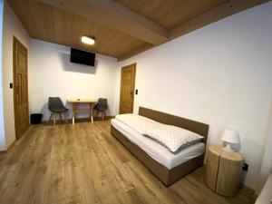 - une chambre avec un lit et une table avec des chaises dans l'établissement Agroturystyka Pod Jodłami, à Żabnica