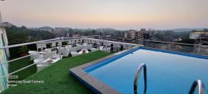 a balcony with a swimming pool on top of a building at Hotel Orion Premiere in Panaji