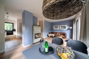 a living room with a table and chairs and a living room at Haus Löwenzahn - Domizil am Ostseewald in Zingst