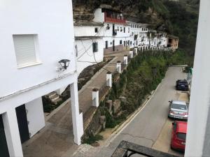 a view from the balcony of a building with a street at casa Encarni, balcon de las cuevas in Setenil