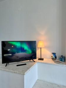 a flat screen tv sitting on top of a counter at Alepochori Seaside Village in Kato Alepochori