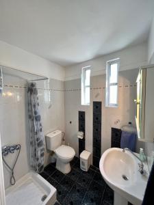 a bathroom with a white toilet and a sink at Alepochori Seaside Village in Kato Alepochori +18 photos