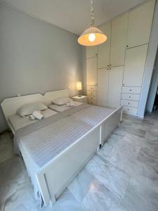 a bedroom with a large white bed in a room at Alepochori Seaside Village in Kato Alepochori