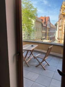 a table and a chair on a balcony at Bording Appartment La Romantica in Fulda