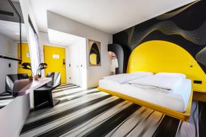 a hotel room with a bed and a sink at Prize by Radisson, Bonn City in Bonn