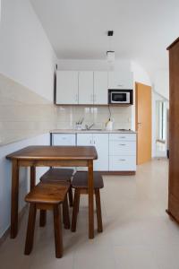 a kitchen with a wooden table and chairs in it at Villa Trio Srima in Srima +43 photos