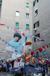 a building with a poster of a soccer player on it at B&B i Murales in Naples