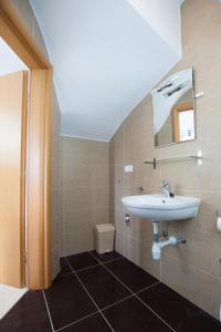 a bathroom with a sink and a toilet at Villa Trio Srima in Srima