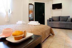 a room with a bed with a plate of food on a table at Villa Anna in Athani +26 photos