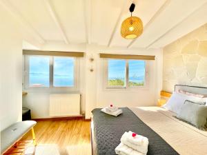 a bedroom with a bed with two towels on it at Villa Evmaria with private swimming pool in Spartýlas