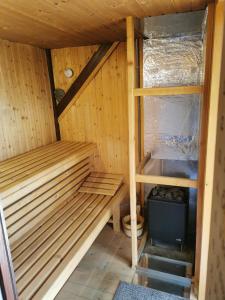 a sauna with a bench and a sink in it at Cottage Barbara with Sauna in Škofja Loka