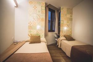 a bedroom with a bed and a mirror at Hostal Marenostrum in Barcelona